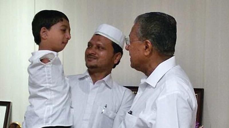 Muhammed Asim and father Muhammed Saeed with Chief Minister Pinarayi Vijayan.