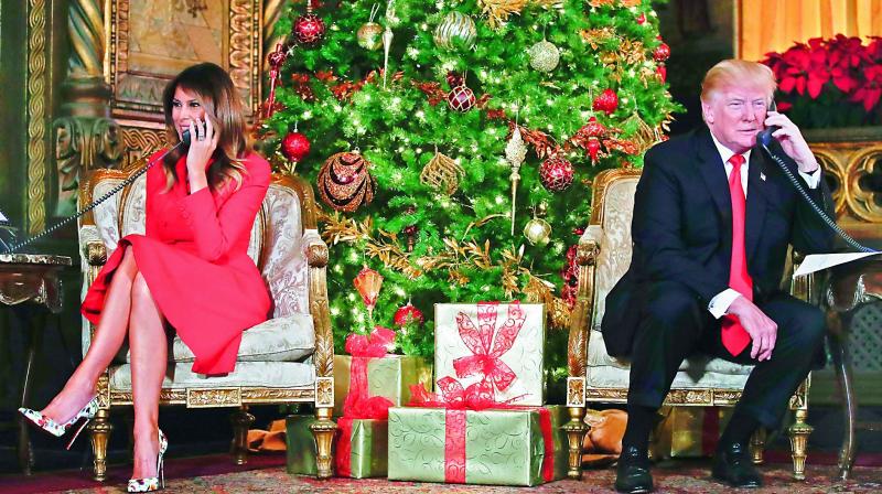 President Donald Trump and First Lady Melania Trump speak on the phone with children as they track Santa Claus movements with the North American Aerospace Defense Command Santa Tracker on Christmas Eve at the Presidents Mar-a-Lago estate in Palm Beach, on Monday. (Photo: PTI)
