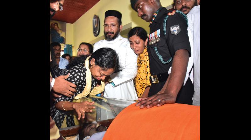 Wife of martyred jawan Sam Abraham pays last respect at his home at Ponakam near Mavelikara  on Monday. (Photo: DC)