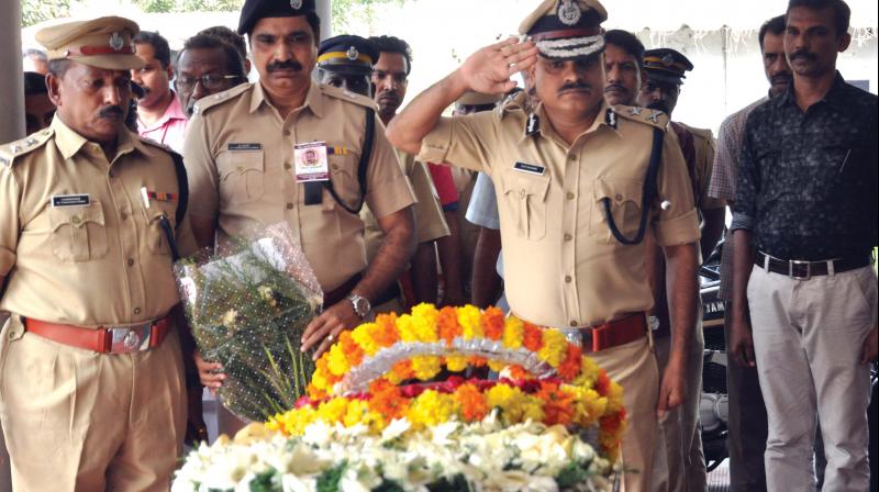 Ernakulam range IG Vijay Sakhre on Monday pays last respects to probationary sub-inspector Gopakumar who committed suicide on Sunday. DCP A.R. Premkumar and ACP K. Lalgy are also seen.  (Photo:  ARUN CHANDRABOSE)