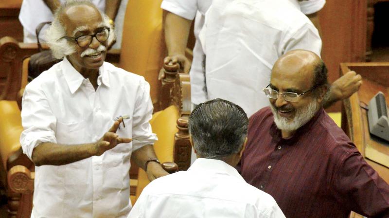 Finance Minister Dr T.M. Thomas Isaac and ports minister Ramachandran Kadannappally having a word with Chief Minister Pinarayi Vijayan after the budget presentation in the assembly on Friday. (Photo: Peethambaran Payyeri)