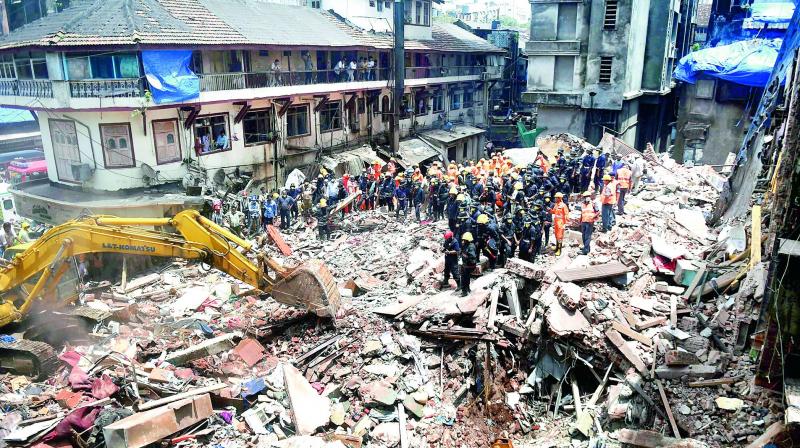 Fire brigade and NDRF personnel carry out search and rescue operations following the collapse of a building at Pakmodiya Street in South Mumbai on Thursday. (Photo: PTI)