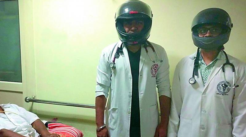 AIIMS doctors wear helmets as a sign of protest against assaults. (Photo: Agencies)