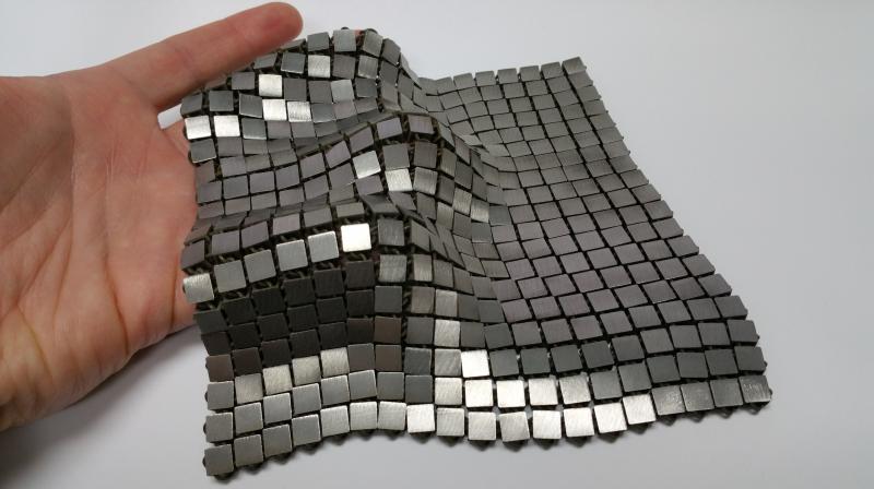 Space Fabric Links Fashion and Engineering Space Fabric Space Fabric folded over This metallic \space fabric\ was created using 3-D printed techniques that add different functionality to each side of the material. Image Credit: NASA/JPL-Caltech