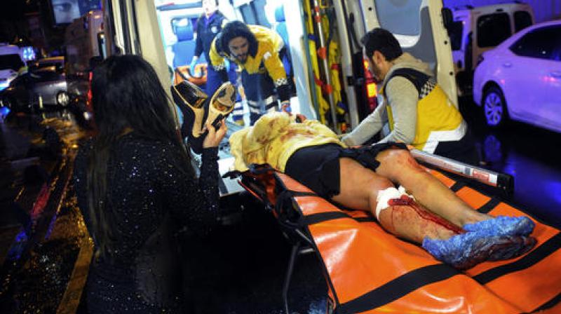 Medics carry a wounded person at the scene after an attack at a popular nightclub in Istanbul. (Photo: AP)