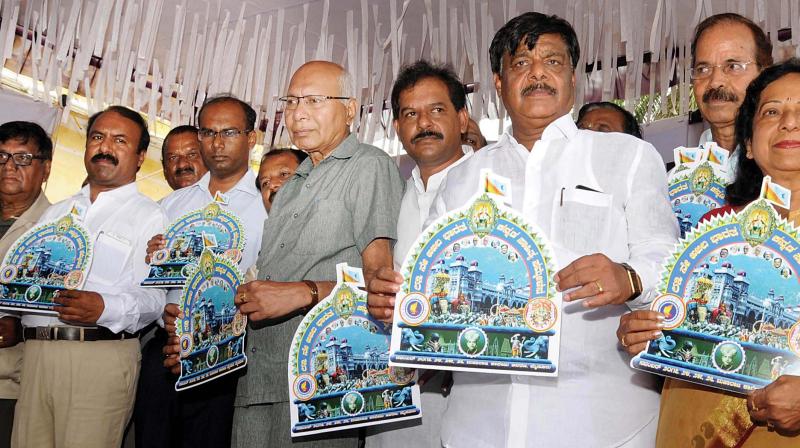 PWD Minister Dr H.C. Mahadevappa launches logo of the All India 83rd Kannada Sahitya Sammelan  in Mysuru on Thursday. (Photo: KPN)