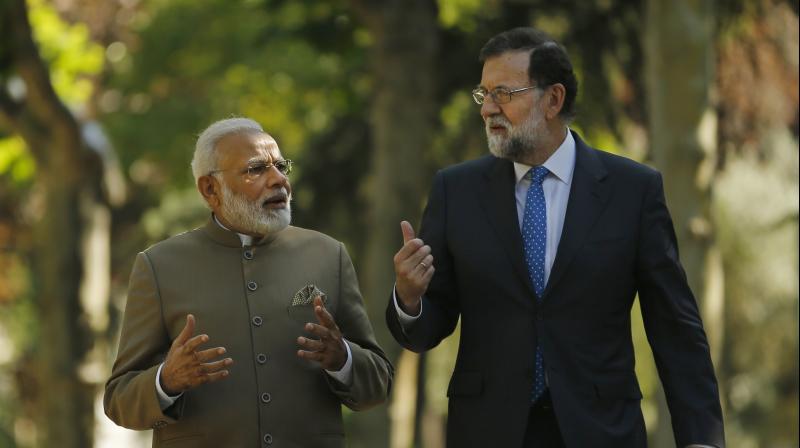 Prime Minister Narendra Modi and Spanish Premier Mariano Rajoy speak while walking in the gardens of the Moncloa Palace in Madrid, Spain. (Photo: AP)