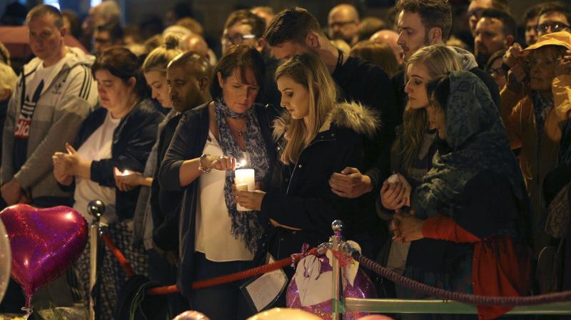 People light candles as they hold a minutes silence in St Anns Square to mark the passing of exactly a week since the Manchester Arena concert blast, in Manchester, England. (Photo: AP)