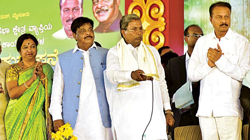 Chief Minister Siddaramaiah and ministers Geeta Mahadevprasad and Dr H.C. Mahadevaappa at the launch of developmental works in Saragur in Mysuru on Thursday. (Photo: DC)