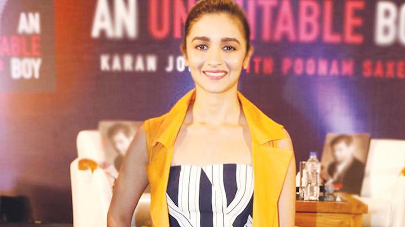 Alia Bhatts look is quirky and young with a mix of bold stripes and yellow