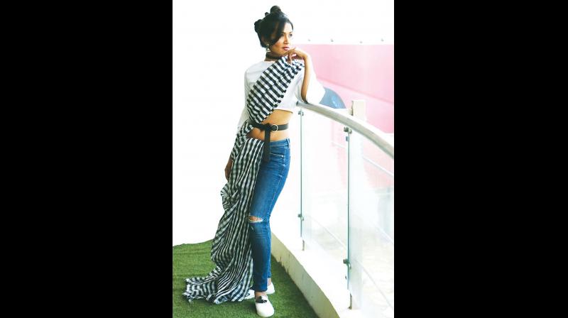 Pair your saree with a crop top, denim and white sneakers