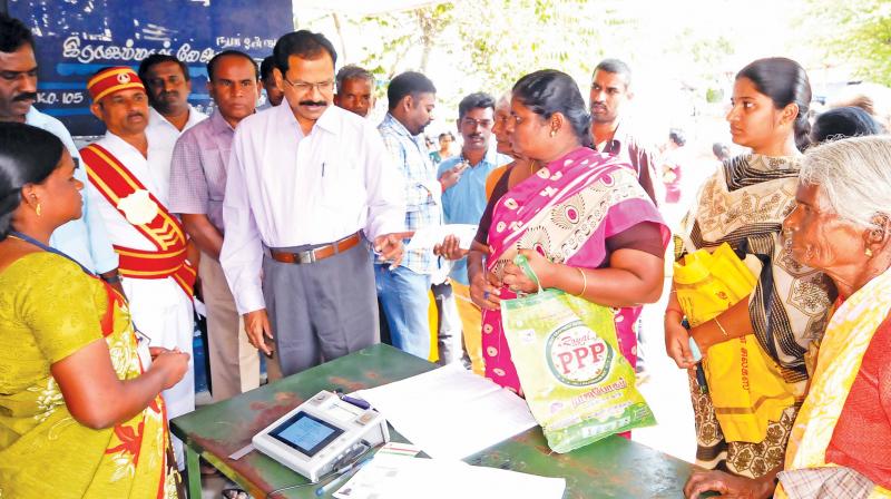 Collector K.S. Palanisamy inspecting the on-going distribution of Pongal gifts at a ration shop in Tirupur on Tuesday. (Image DC)