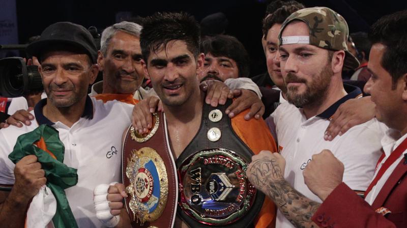 Indian boxing and WBO Asia-Pacific Super Middleweight champion Vijender Singh, centre, celebrates after winning the double tittle against WBO Oriental Super Middleweight champion of China Zulpikar Maimaitiali in Mumbai (Photo: AP)