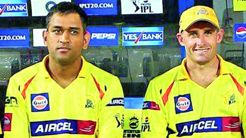 A file photo of M.S. Dhoni (left) and Michael Hussey.