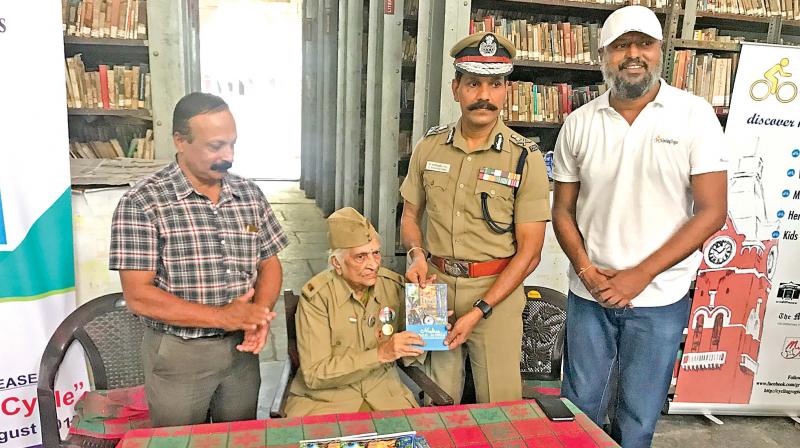 Saraswathi Rajamani (seated), who in 1942, was recruited to the INA and was part of the armys military intelligence wing, releases the booklet Madras, by cycle, at the Madras Literary Society. ADGP Sylendra Babu and Sharath Nambiar COO Dakshina Chitra, received first and second copies from her. Ramanujar Moulana, founder, Cycling Yogis, is at extreme right. (Photo: DC)