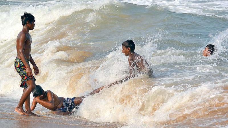 Despite several warnings from the police, there seems to be no stopping unsafe frolicking in the Marina beach.(inset) warning board	 (Photo: DC)