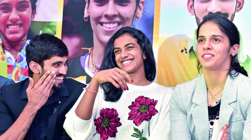 Shuttlers Srikanth Kidambi (from left), P.V. Sindhu and Saina Nehwal share a light moment at a felicitation ceremony in New Delhi on Thursday (Photo: AP)