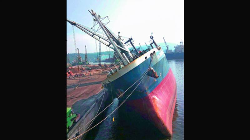 A foreign vessel tilted to one side at the EQ berth No. 5 at Visakhapatnam Port Trust in Visakhapatnam on Wednesday.