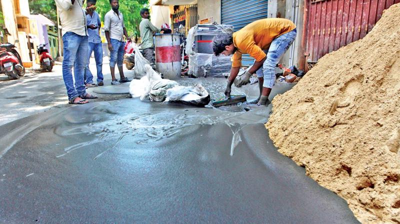 A man cleans black foam that seeped out from the ground into a house situated close to a metro rail work station at Washermanpet, due to the metro tunnel boring work. (Photo: DC)