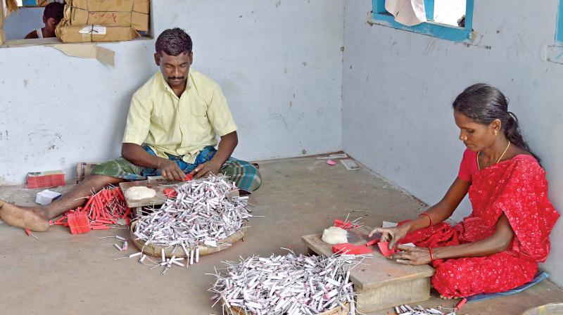 Workers prepare crackers at a unit in Sivakasi.