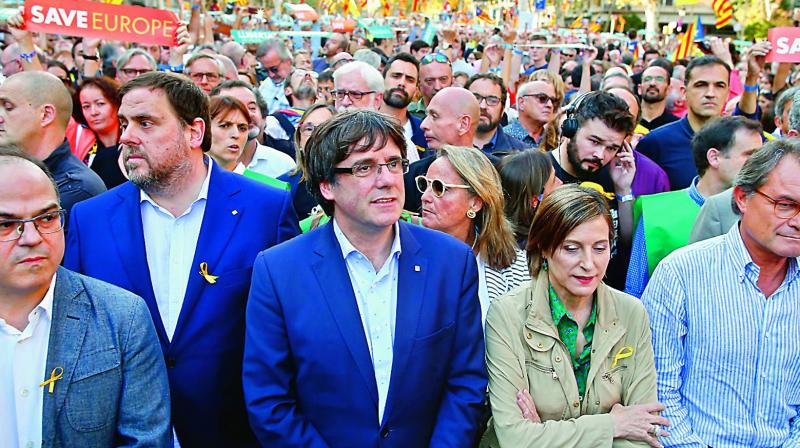 Catalan President Carles Puigdemont, centre, and other Catalan leaders take part in a march to protest against the courts decision to imprison civil society leaders, in Barcelona, Spain, on Saturday (Photo: AP)