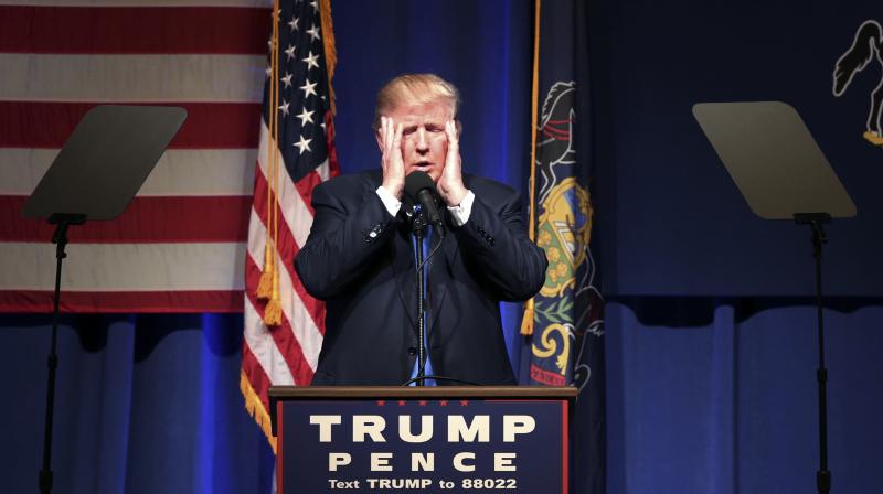 Republican presidential candidate Donald Trump holds his head in his hands as he speaks during a campaign. (Photo: AP)