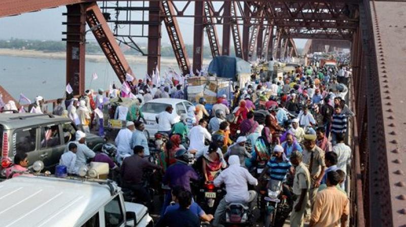 Baba Jai Gurudev supporters crossing the crowded Rajghat Bridge in Varanasi. (Photo: PTI)