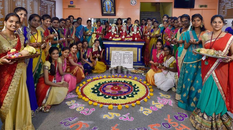 Girls of a college create a rangoli to celebrate Ugadi festival at a college in Chennai on Saturday. (Photo: PTI)