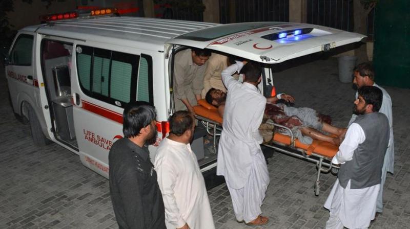 Pakistani men shift an injured victim into a hospital in Quetta. (Photo: AFP)