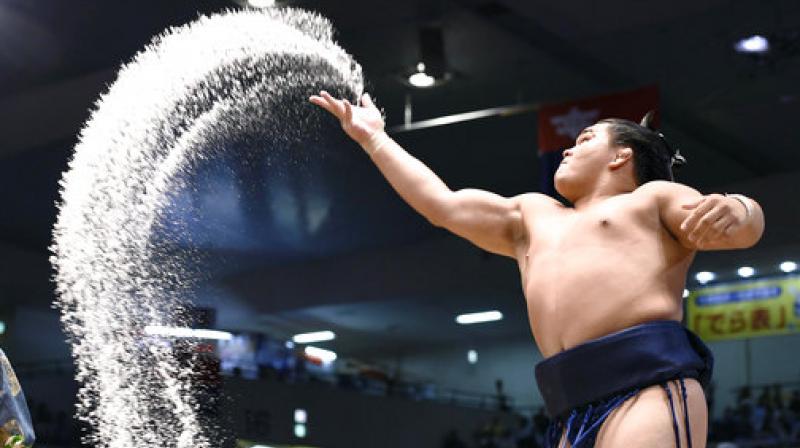 In this Sunday, July 9, 2017 photo, sumo wrestler Terutsuyoshi throws salt in the air during the Nagoya Summer Grand Sumo tournament in Nagoya, central Japan.  (All Photos: AP)