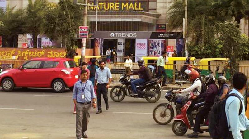 Pedestrians crossing Old Madras Road near RMZ building. (Photo: DC)
