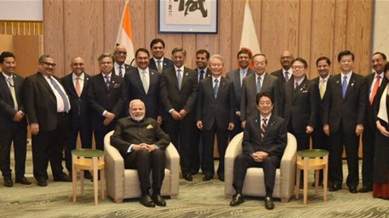 Prime Minister Narendra Modi and his Japanese counterpart Shinzo Abe in a group photo with the members of India-Japan Business Leaders Forum in Tokyo. (Photo: AP))