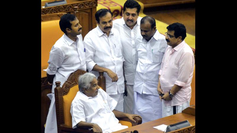 Former chief minister Oommen Chandy in a pensive mood with UDF MLAs around him before the tabling of the solar commission report in the Assembly on Thursday. (Photo: Peethambaran Payyeri)