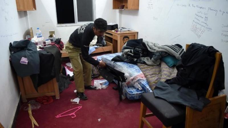 Policeman inspect Mashal Khans hostel room.  (Photo: AFP)