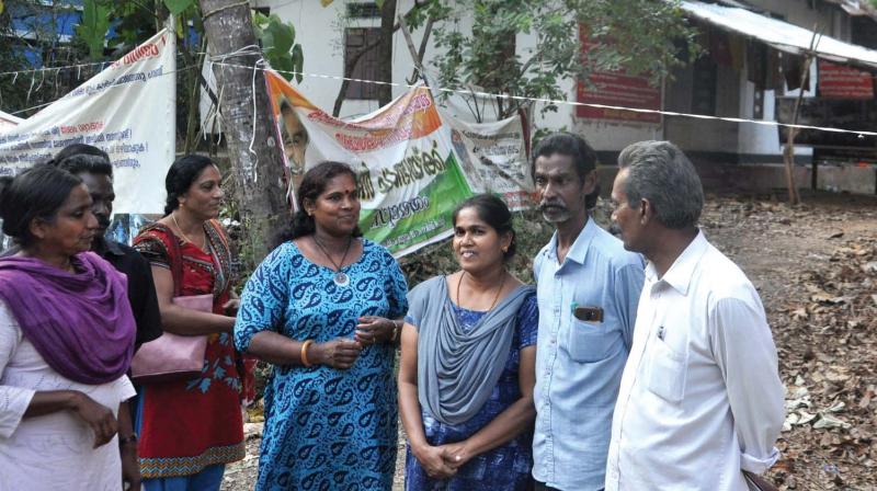Preetha and husband Shaji (second and third from right) along with anti-Sarfaesi activists in front of their house at Pathadipaalam in Kochi on Tuesday.(Photo: SUNOJ NINAN MATHEW.)