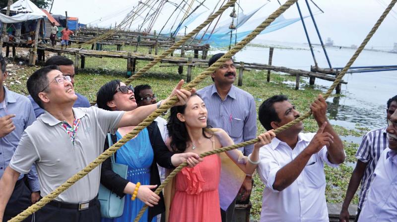 Le Yucheng, Chinese ambassador to India,  tries his hand at the famed Chinese net in Fort Kochi.