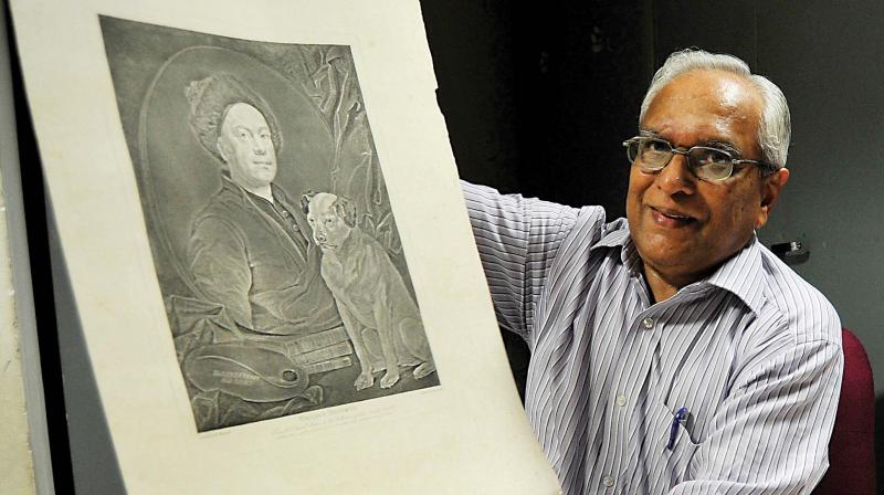 V.G. Narendra holding a self-portrait by William Hogarth