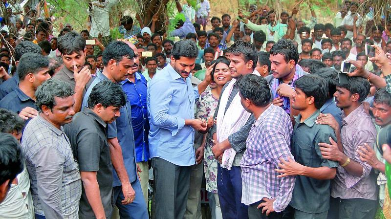 YSR Congress President Y.S. Jagan Mohan Reddy console the family members of victim at Cherukulapadu village in Kurnool district on Monday. (Photo: DC)