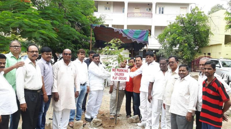 Residents of Seshachalam Colony of West Marredpally planting trees.