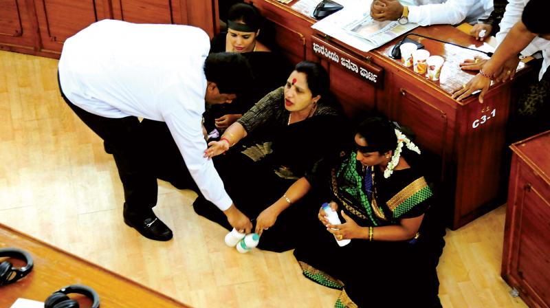 The three women corporators  Manjula Narayanaswamy, JD(S), Mamata Vasudev (BJP) and Asha Suresh (Congress)  protested in the well of the House with bottles of poison liquid in front of them.