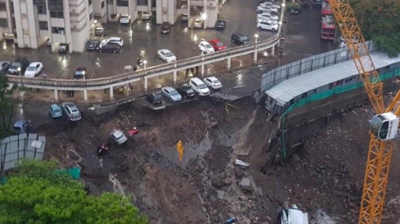 Seven cars were damaged after wall of an under-construction building collapsed at Vidyalankar road in Wadalas Antop Hill following heavy rains. (Photo: Twitter | @sanjaynirupam)