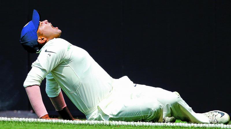 Prithvi Shaw grimaces in pain after injuring his ankle during a warm-up game in Sydney.  (AP)