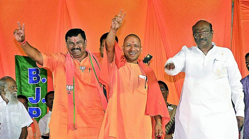 Uttar Pradesh Chief Minister Yogi Adityanath and BJP Goshamahal Assembly Constituency candidate T. Raja Singh at a public meeting on Sunday.  (P. Surendra)