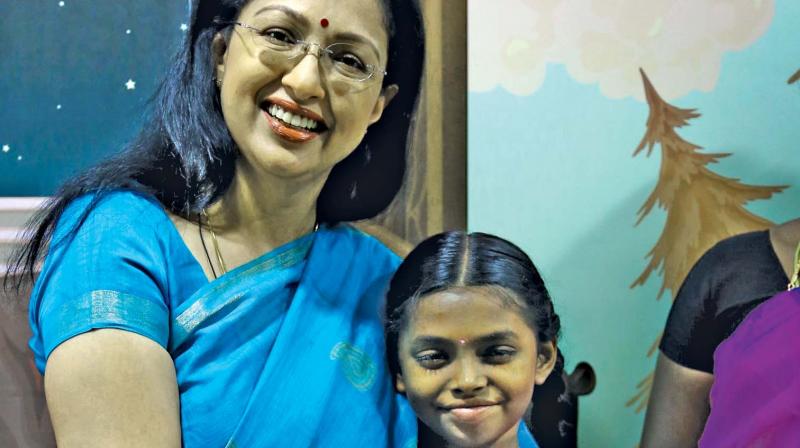 Gautami gifts a cancer afflicted child.