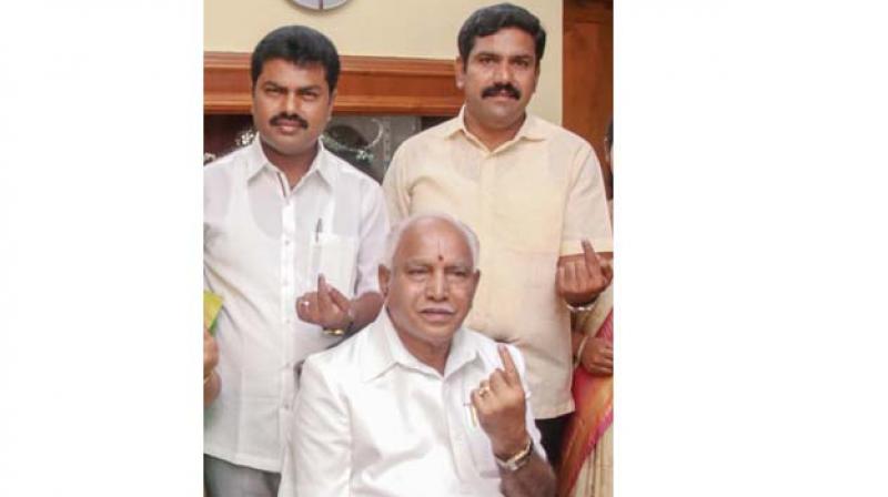 BJPs chief ministerial candidate B.S. Yeddyurappa and his family members after casting their votes at Shikaripur in Shivamogga  district on Saturday 	 ( Image: PTI)