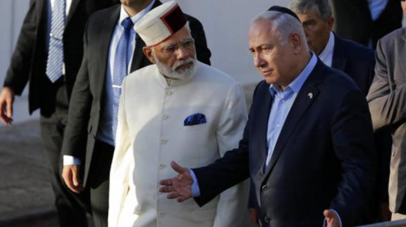 Indian Prime Minister Narendra Modi, left, accompanied by Israeli Prime Minister Benjamin Netanyahu, visits the Yad Vashem Holocaust memorial museum in Jerusalem. (Photo: AP)