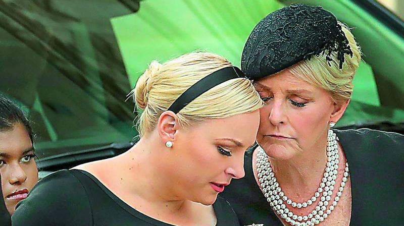 Meghan McCain and her mother Cindy McCain embrace as the casket of the late Senator John McCain arrives at the Washington National Cathedral for the funeral service on Saturday. (Photo: AFP)