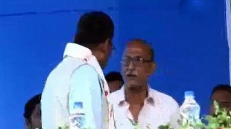 Union Minister (left) Rajen Gohain speaks with the retired teacher in Assams Nagaon. (Photo: ANI)