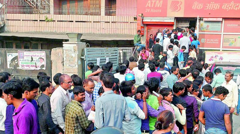 People queue up at outside a bank in New Delhi on Saturday. (Photo: PTI)