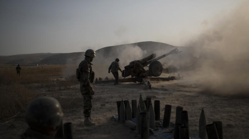 Kurdish Peshmerga soldiers fire artillery at Islamic State positions in Bashiqa, east of Mosul, Iraq. (Photo: AP)